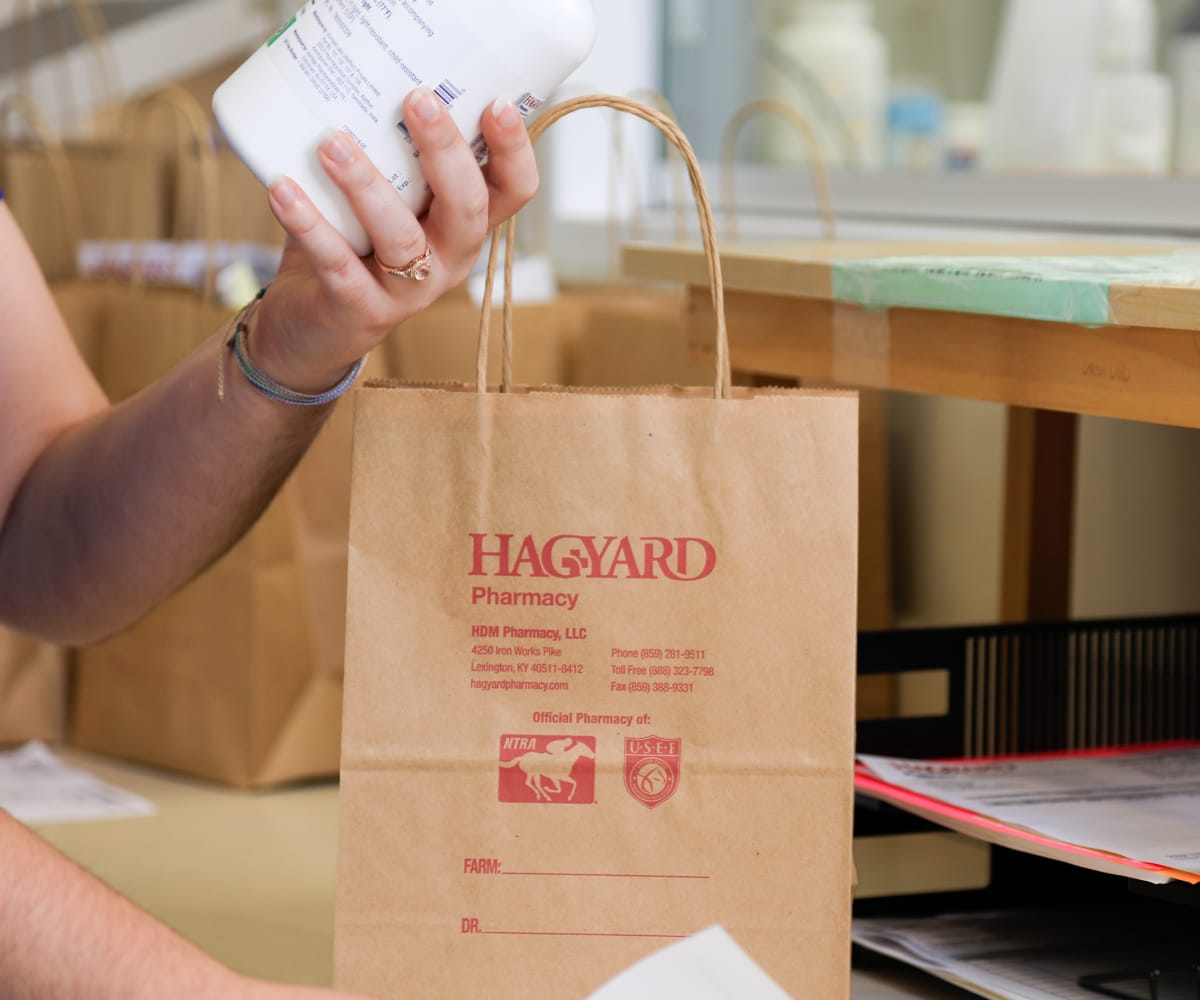 Hagyard Pharmacy team member packing a prescription